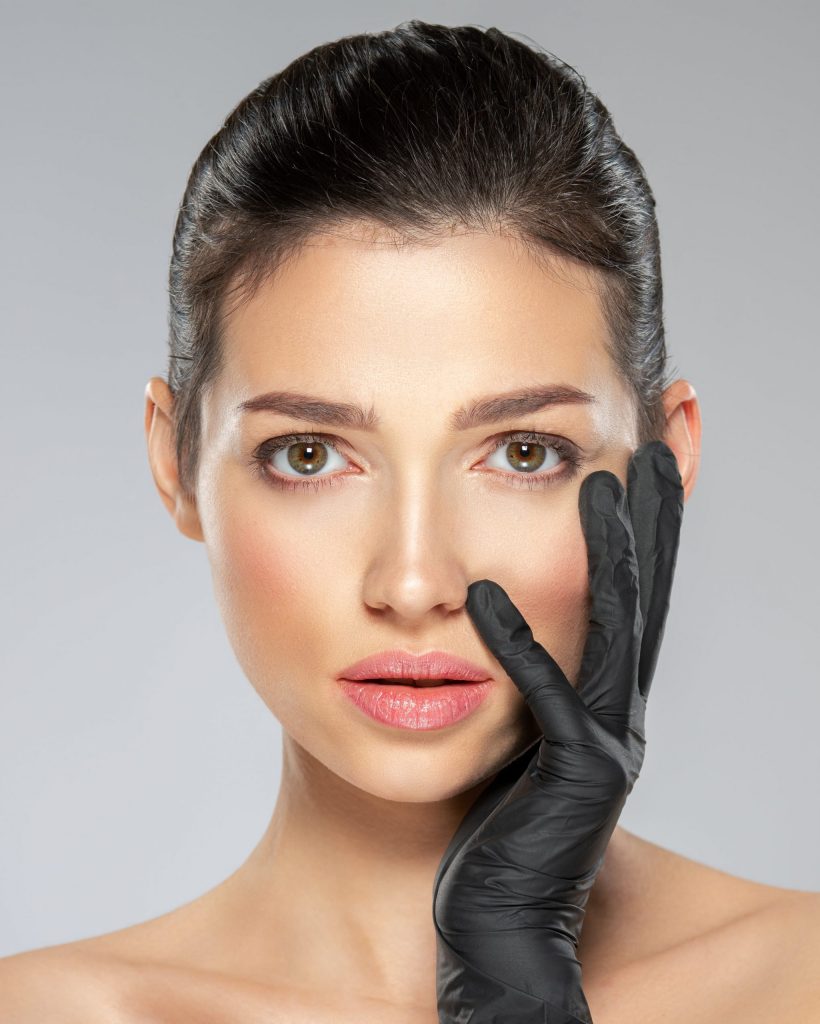 woman-is-touching-her-face-before-plastic-surgery-2021-09-01-01-20-50-utc-min